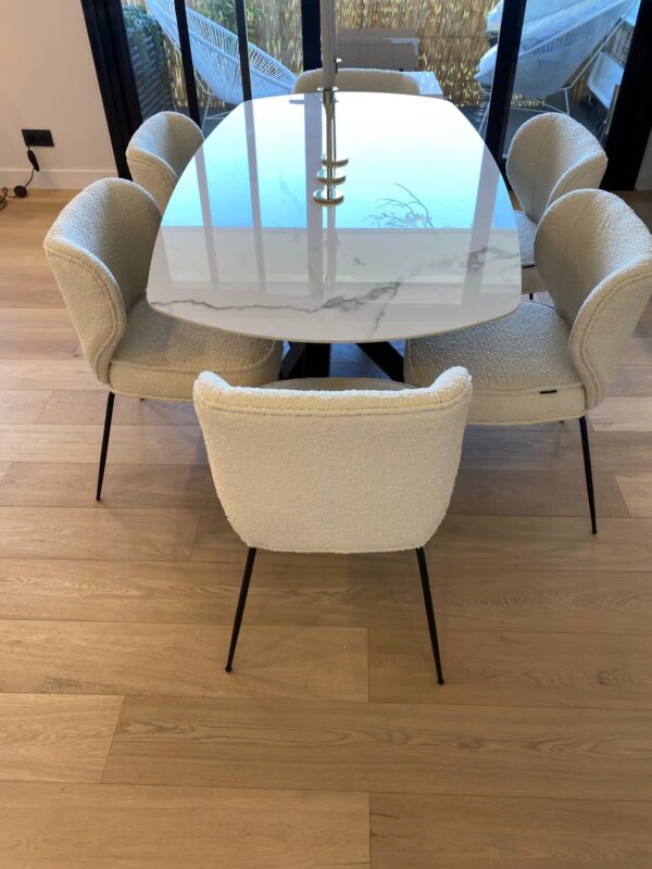 Table à manger sur mesure alliant un plateau en céramique marbre blanc et un piétement central en métal noir au design Mikado. Une pièce unique qui sublime votre intérieur avec élégance et modernité
