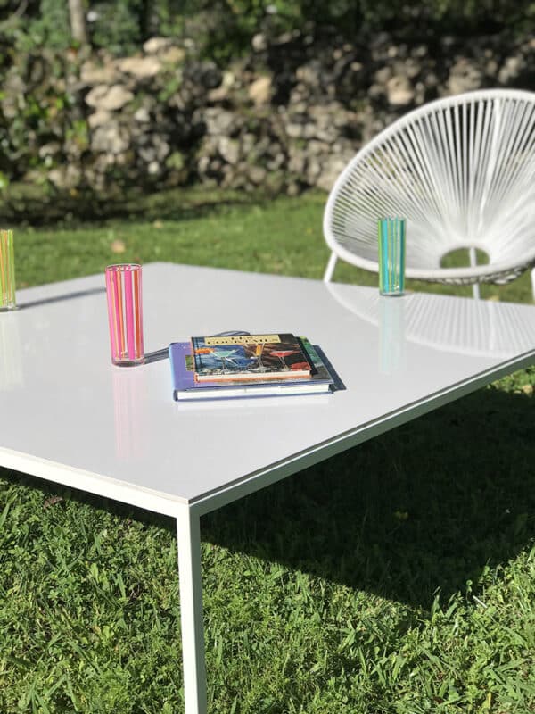 Table basse de jardin avec plateau blanc en céramique et pied en aluminium thermolaqué de couleur blanc.