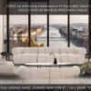 Salon séjour ouvert par une large baie vitrée sur un fleuve et son pont suspendu avec, au premier plan les canapés en tissu beige NEW YORK 3 places et 2 places, le fauteuil en tissu beige CAIRO et la table basse ovale TESSA C avec plateau en céramique marbre Calacatta et piètement fin au design élégant.